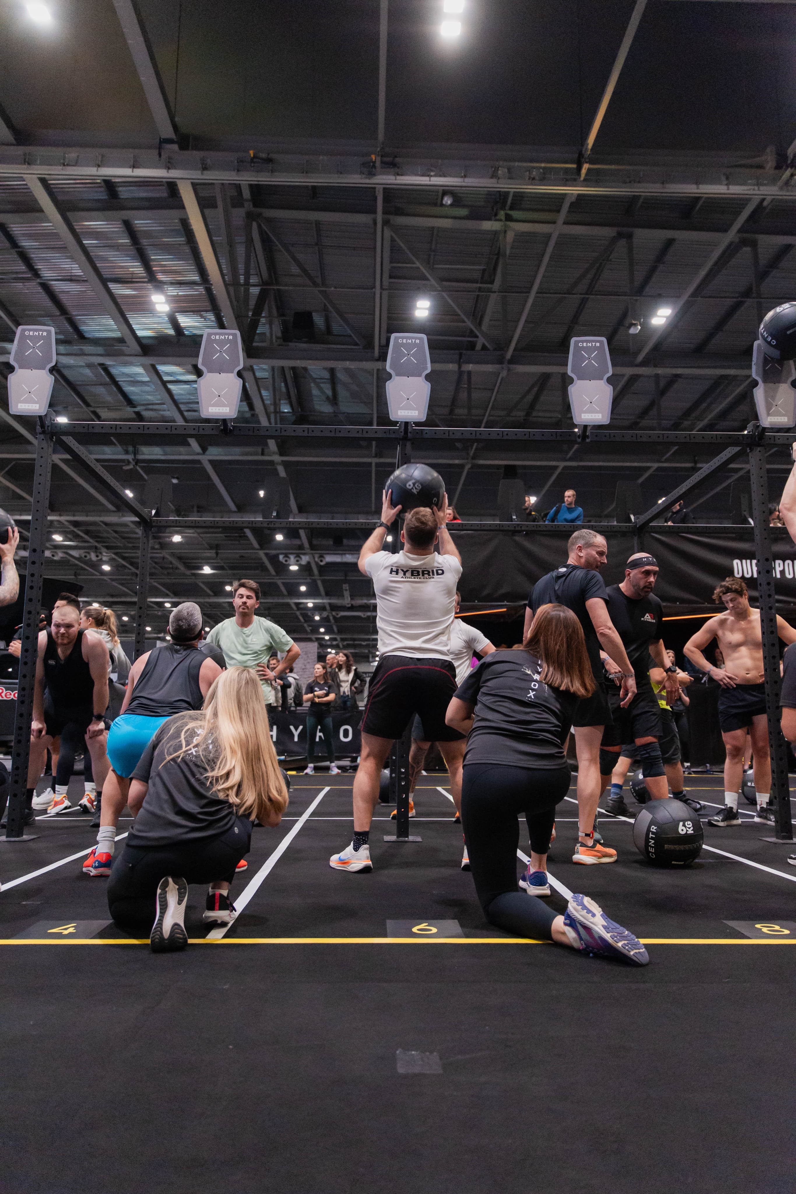 Athletes training wall balls at a Hybrid Athlete Club session